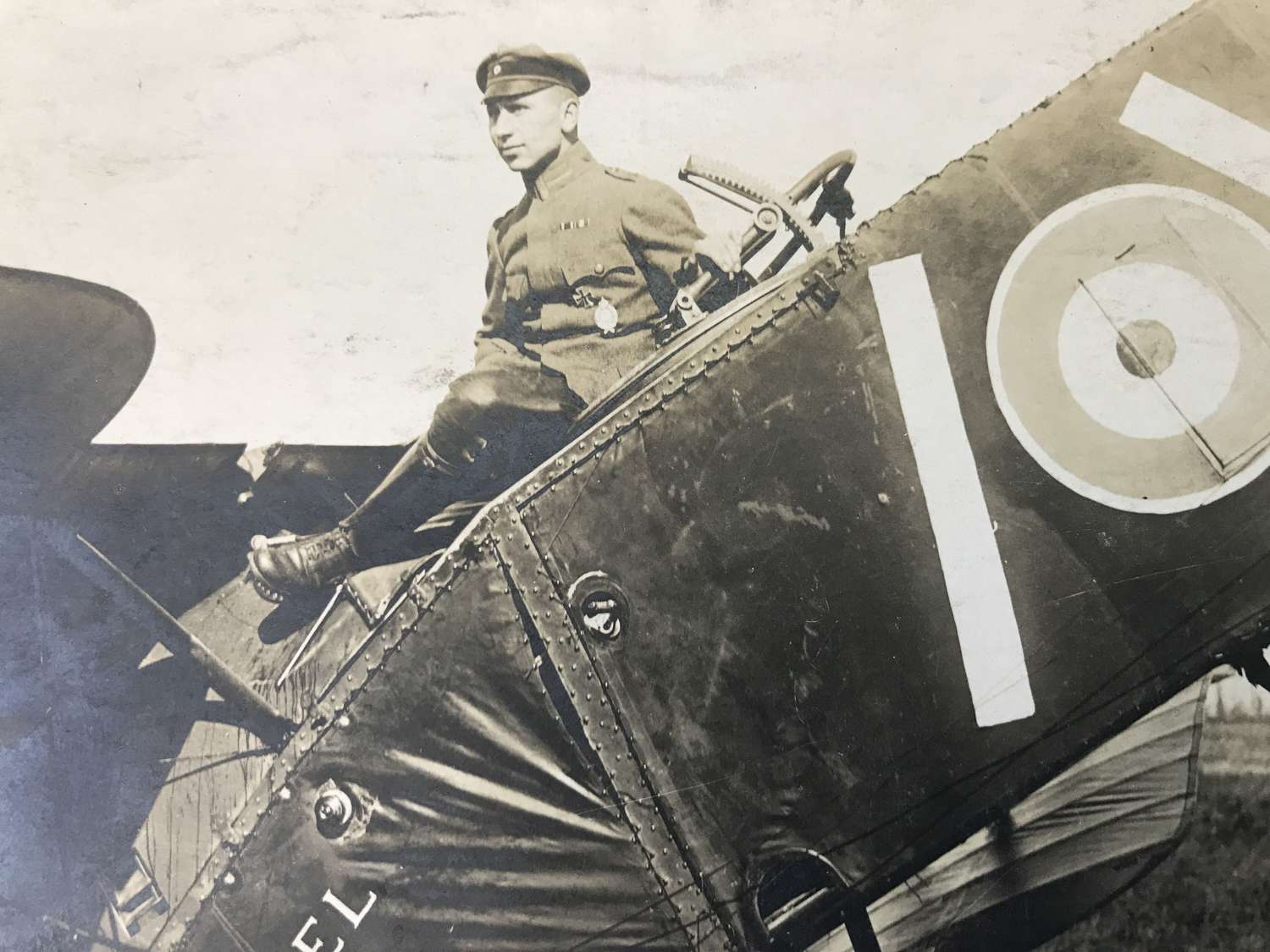 A Postcard Of a German pilot sitting on a Bristol fighter